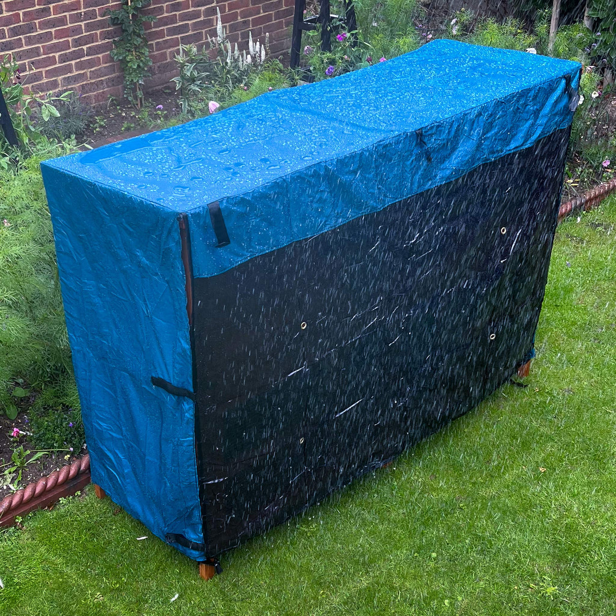 4ft rabbit hutch rain cover double sitting in a garden on a wet day