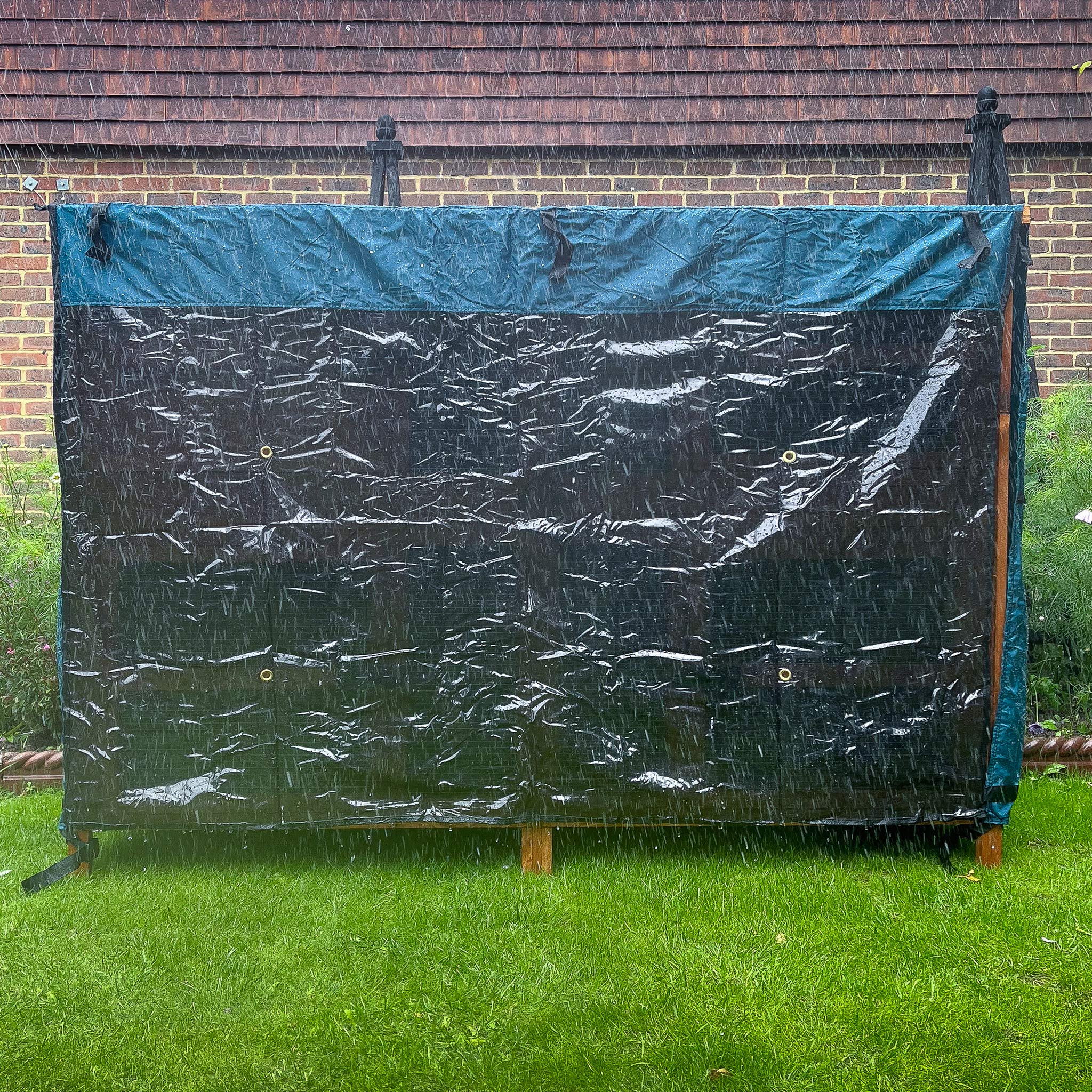 5ft double rabbit hutch rain cover day dry cover placed in a garden on a rainy day