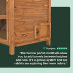 Wooden rabbit hutch with text about burrow portal install kits on a green background