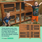 Two children standing next to a wooden rabbit hutch with a Trustpilot review overlay.