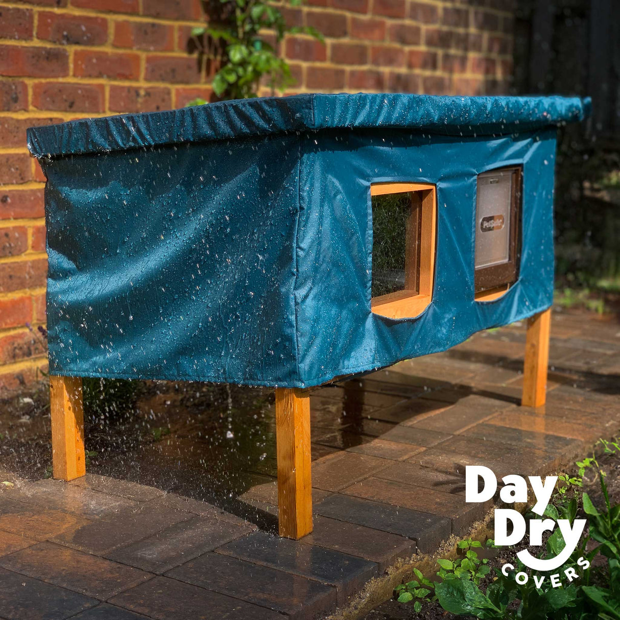 XL cat house rain cover in the garden under a cloudy sky