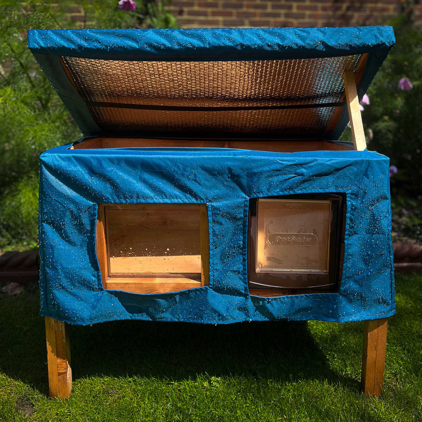 cat house rain cover in the garden under a cloudy sky roof open