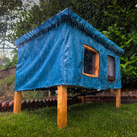 XL cat house rain cover in the garden under a cloudy sky water resistant legs lifting house up off the ground