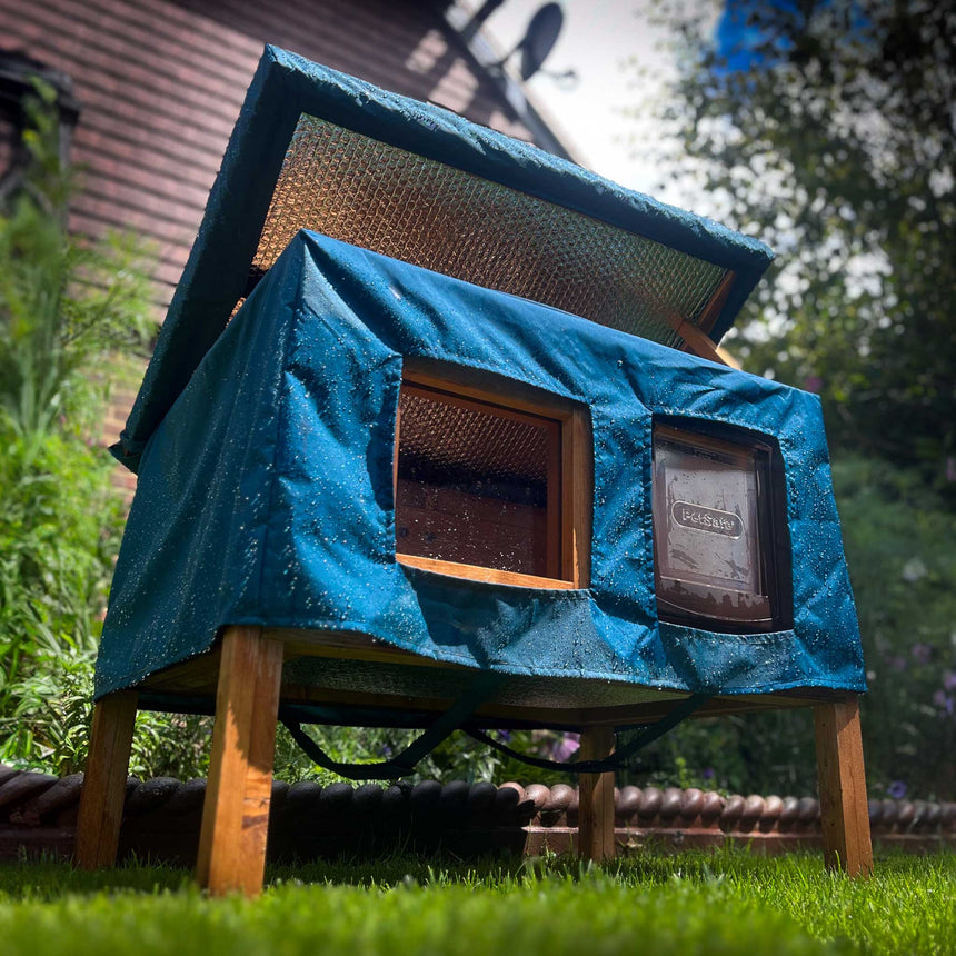 cat house rain cover in the garden under a cloudy sky roof opens and closes
