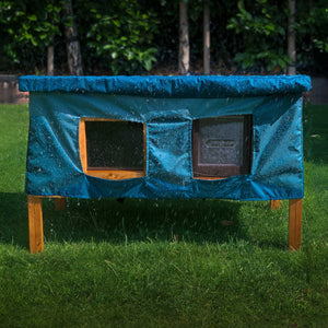 XL cat house rain cover in the garden under a cloudy sky water resistant window and door opening