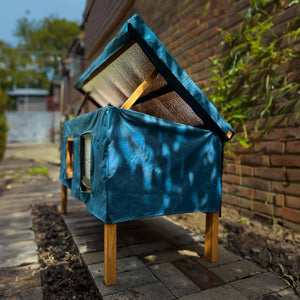 XL cat house rain cover in the garden under a cloudy sky water resistant roof opens