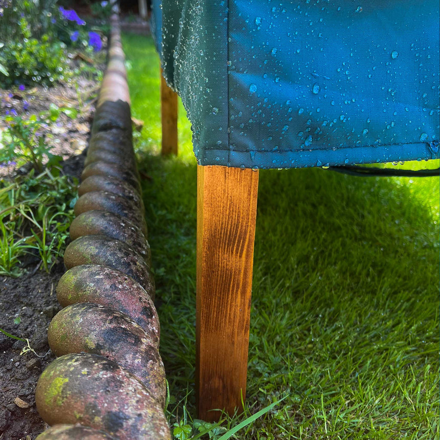 cat house rain cover in the garden under a cloudy sky rear leg velcro straps