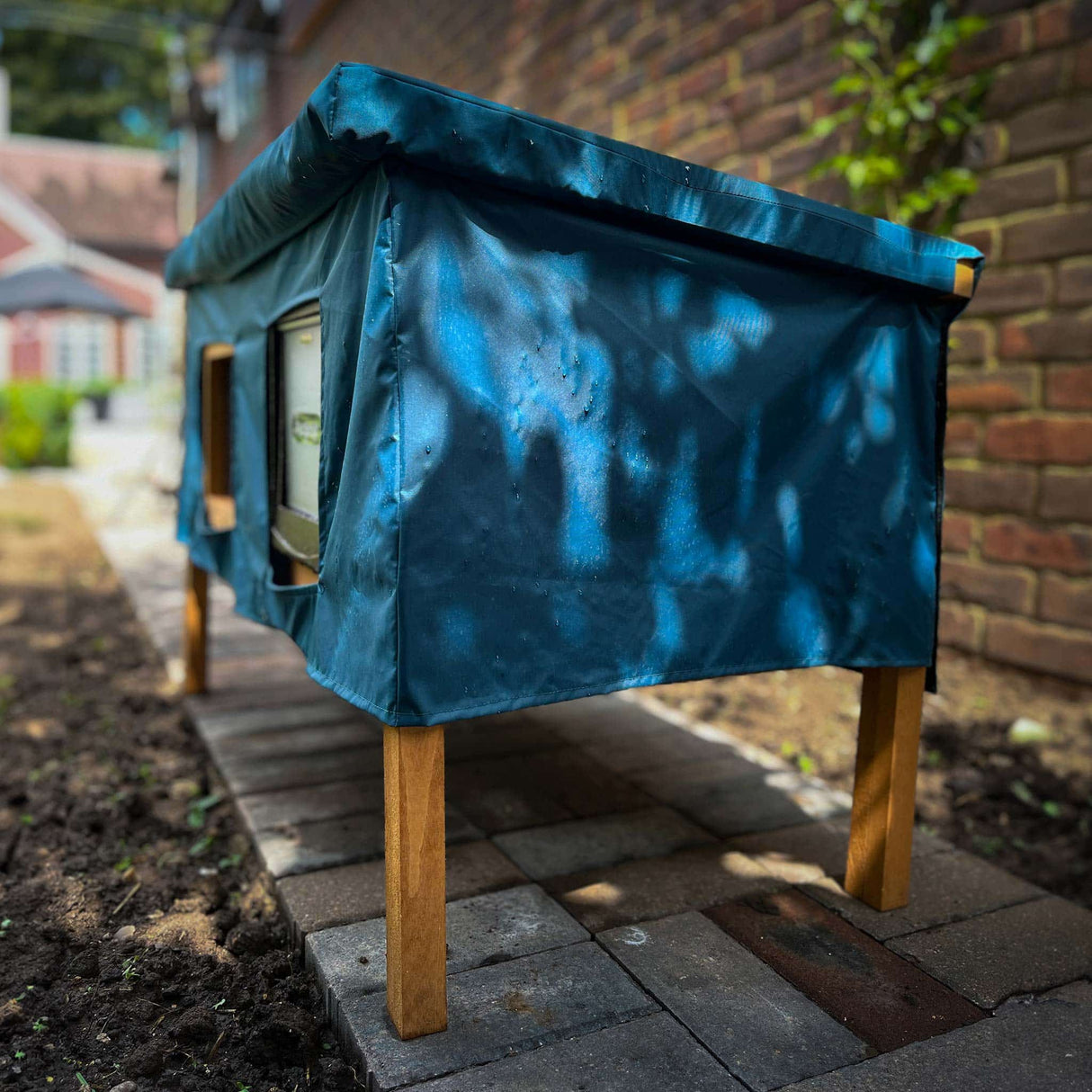 XL cat house rain cover in the garden under a cloudy sky water resistant use for stray cats