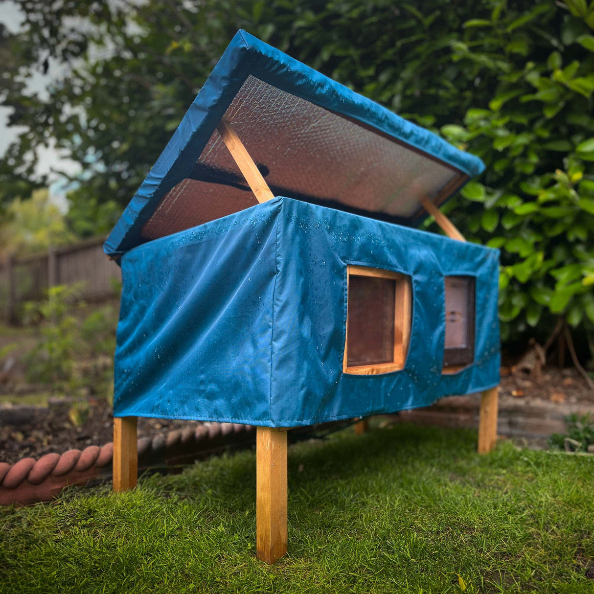 XL cat house rain cover in the garden under a cloudy sky water resistant easy access form the open roof