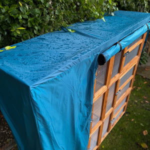 guinea pig hutch cover 4ft triple in a garden as it rains