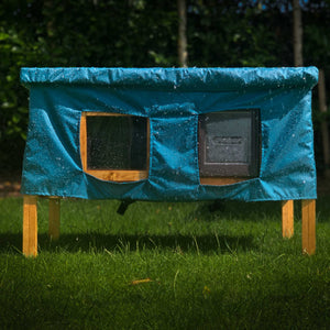 XL cat house rain cover in the garden under a cloudy sky on the grass