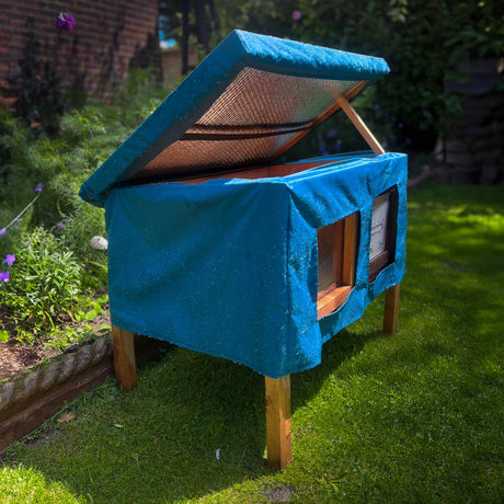 cat house rain cover in the garden under a cloudy sky easy access from roof