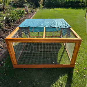 rabbit run shade on a run in a garden covering one side of the run