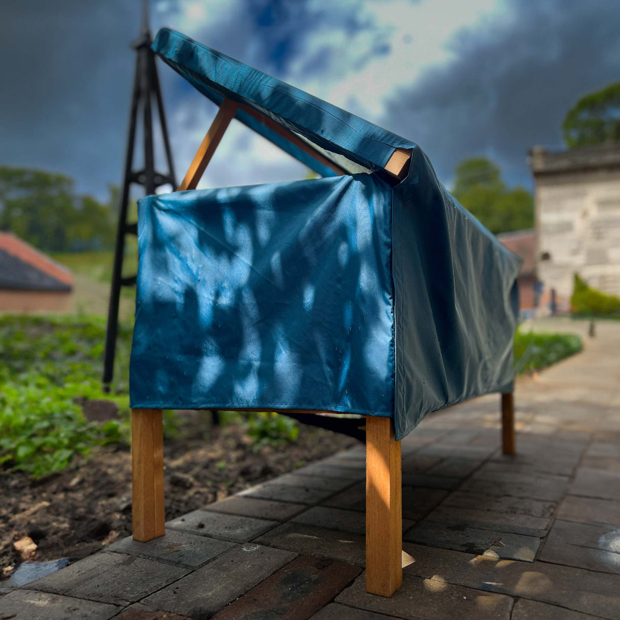 XL cat house rain cover in the garden under a cloudy sky open roof