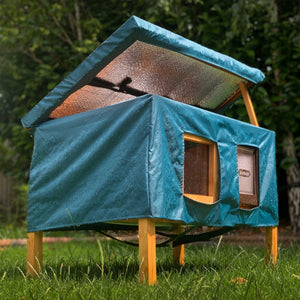 XL cat house rain cover in the garden under a cloudy sky open roof insulation