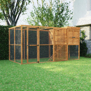 Wooden chicken coop in a garden setting with trees and a house in the background